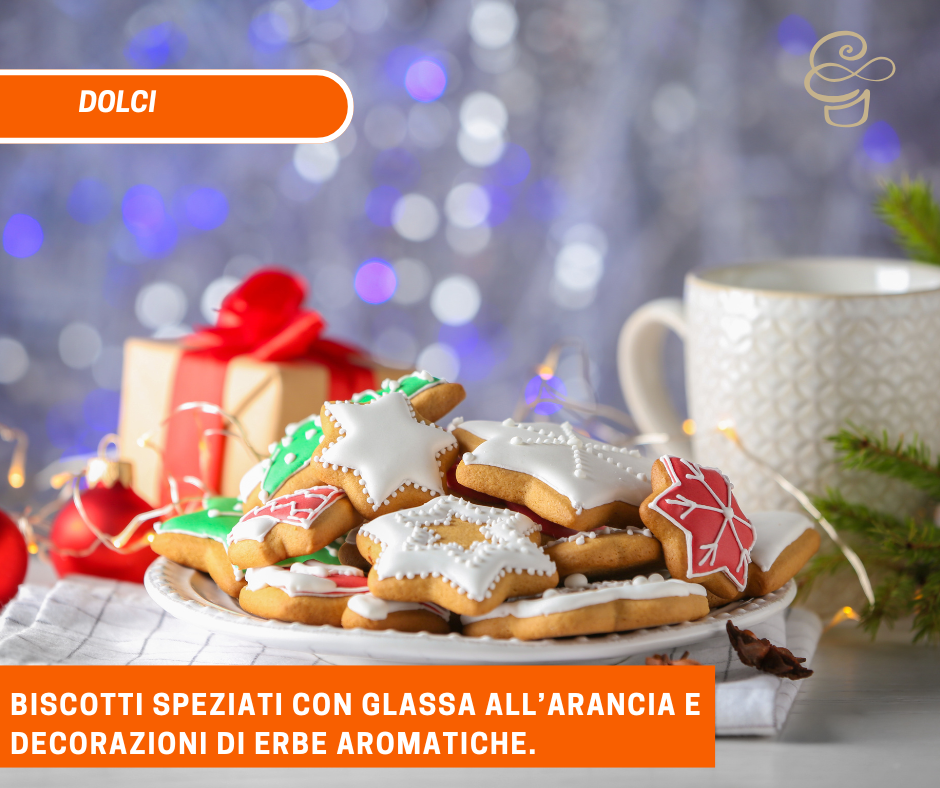 Biscotti speziati con glassa all’arancia e decorazioni di erbe aromatiche.
